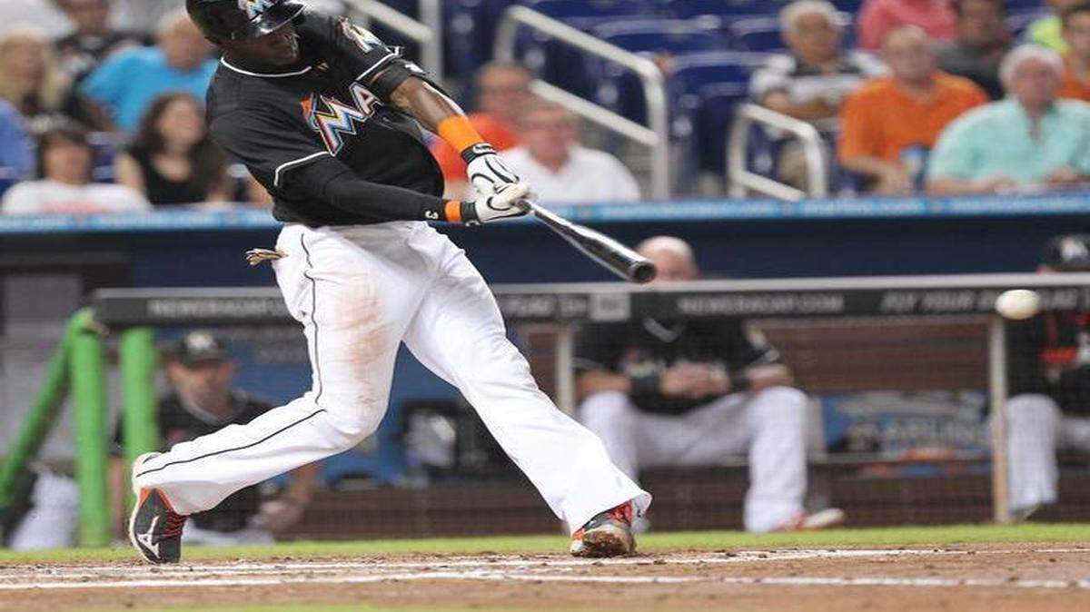 
Miami Marlins shortstop Adeiny Hechavarria hit a single during the second inning against the Philadelphia Phillies in the last home game at Marlins Park in Miami on Thursday, September 25, 2014.
