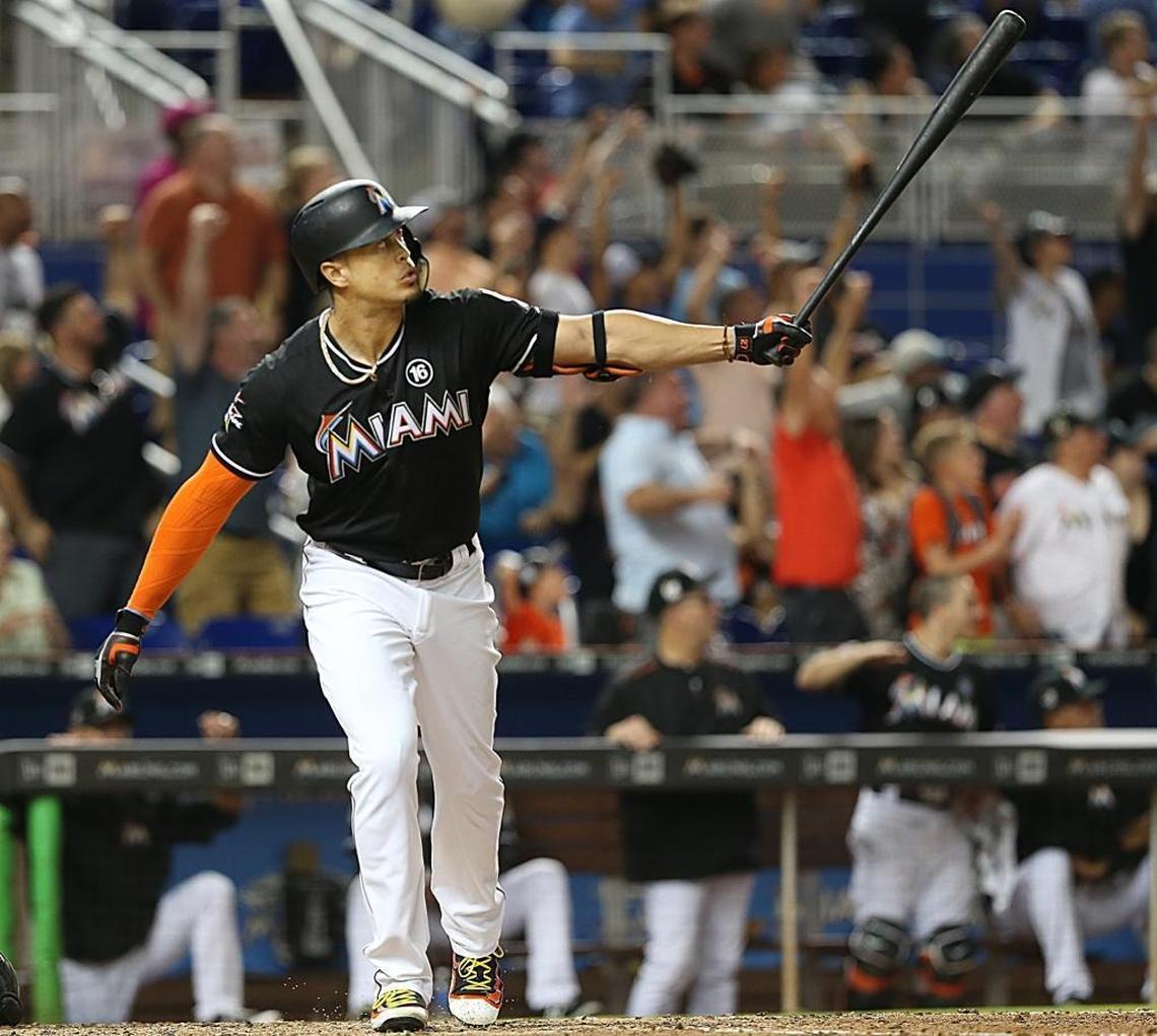 Miami Marlins' right fielder Giancarlo Stanton, hits a three runs home run in the fourth inning of the Miami Marlins vs The Colorado Rockies game at Marlins Park in Little Havana in Miami on Saturday, Aug. 12, 2017.