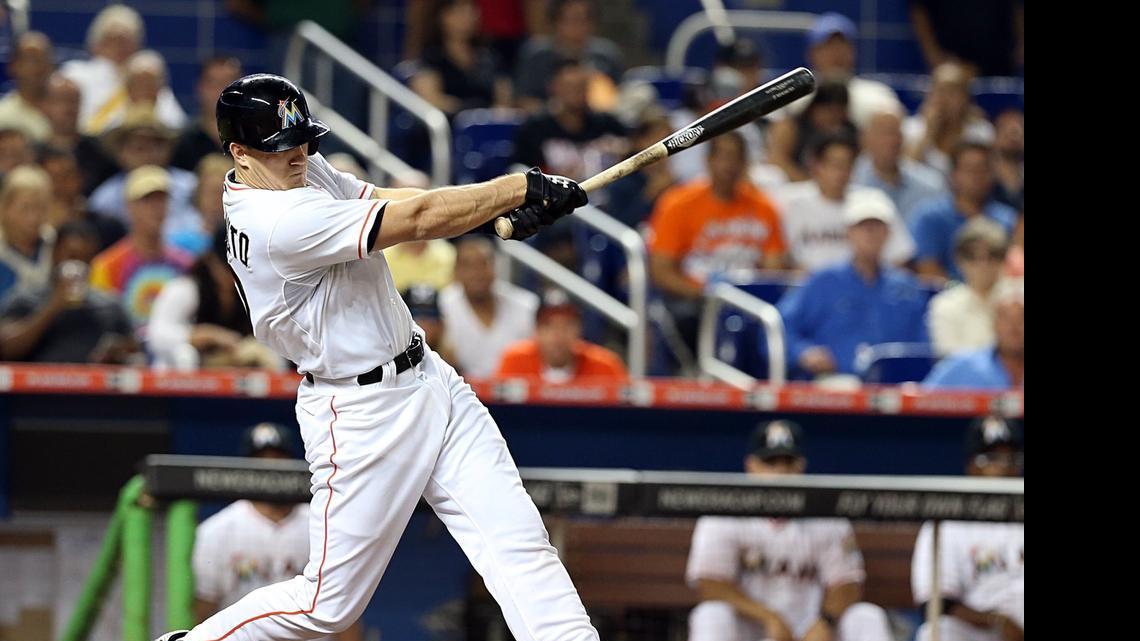 
Miami Marlins catcher J.T. Realmuto hits an RBI single in the sixth inning against the New York Mets at Marlins Park on Tuesday, April 28, 2015.
