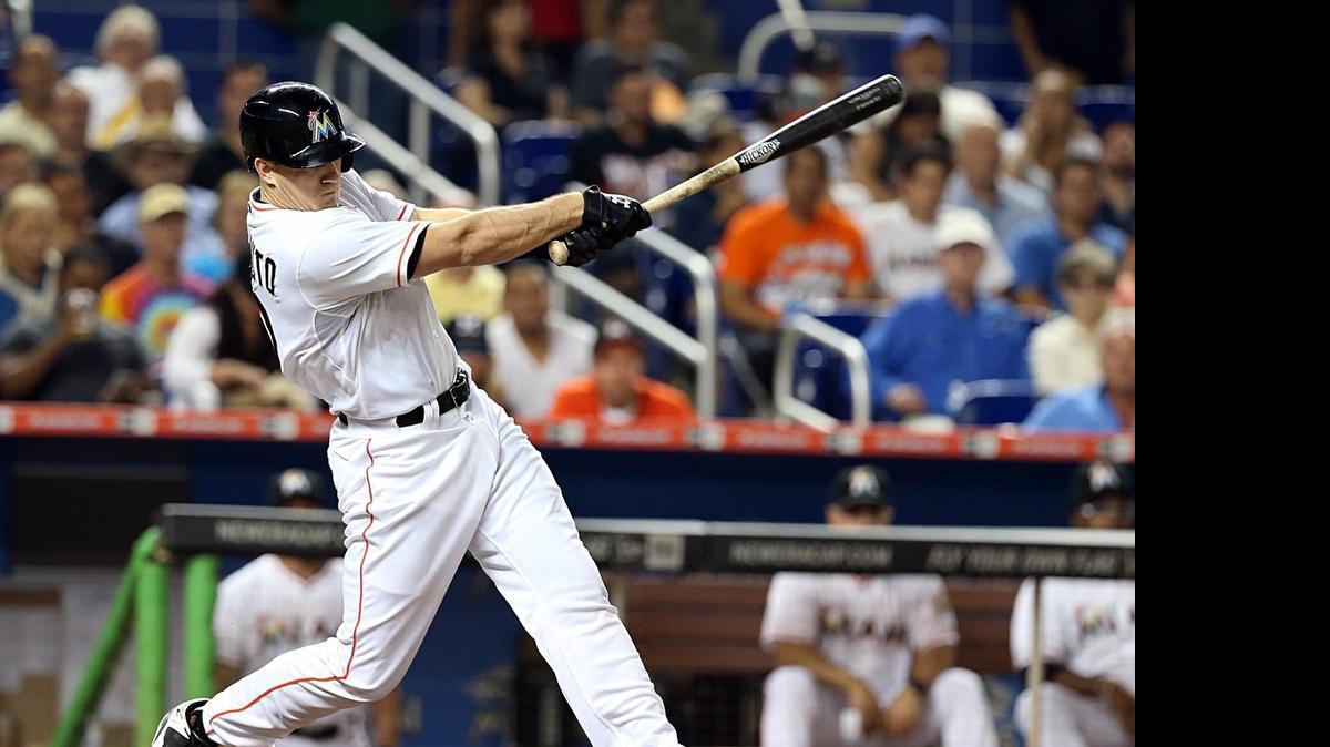 
Miami Marlins catcher J.T. Realmuto hits an RBI single in the sixth inning against the New York Mets at Marlins Park on Tuesday, April 28, 2015.
