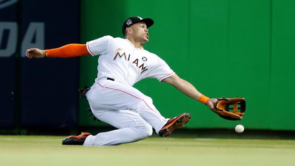 Miami Marlins right fielder Giancarlo Stanton is unable to catch a ball hit by Houston Astros' Jose Altuve for a double during the ninth inning of a baseball game, Wed., May 17, 2017, in Miami. The Astros defeated the Marlins 3-0.