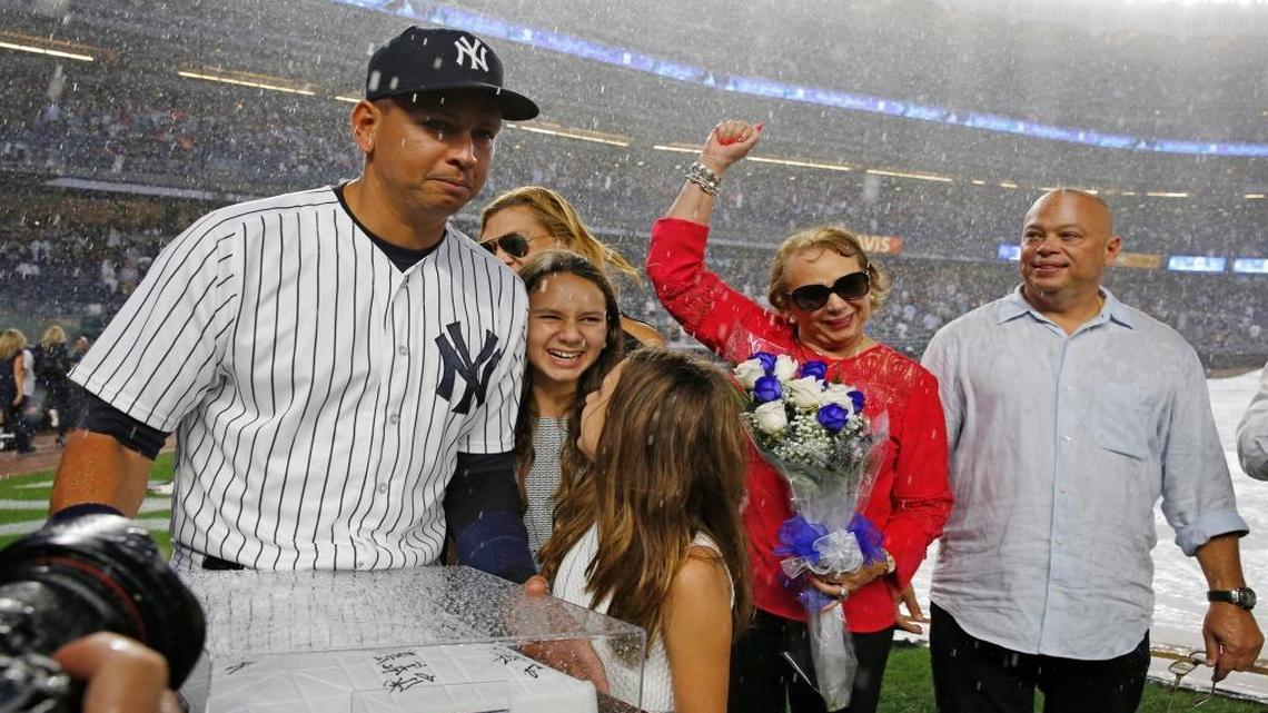 New York Yankees Alex Rodriguez (13) leaves the field with his daughters Natasha and Ella and his mother Lourdes Navarro, second from right, brother and sister Joe Dunand, right, after accepting a signed base during a pregame ceremony before his final game as a player at Yankee Stadium in New York, Fri., Aug. 12, 2016.