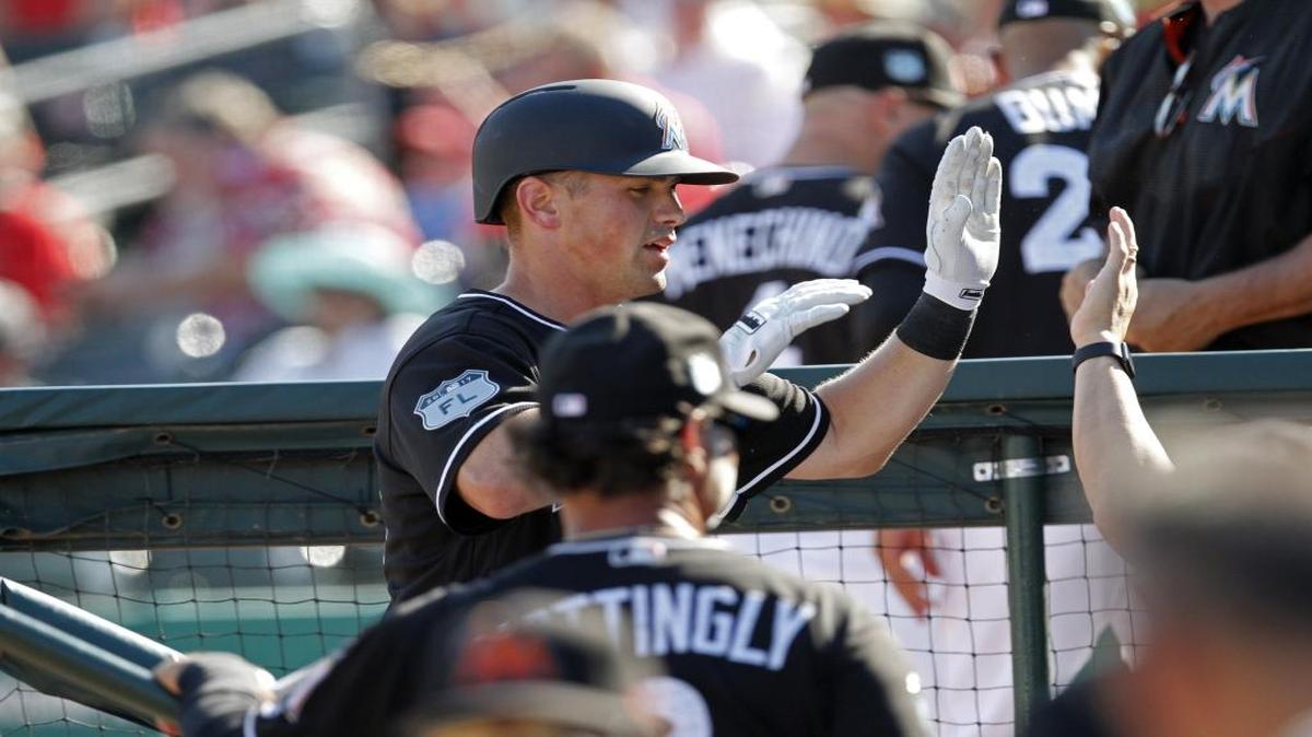 Miami Marlin's first baseman Tyler Moore is congratulated by teammates after a seventh-inning home run pushed the Marlins to an 8-7 lead during Saturday's 8-7 win over the St. Louis Cardinals at Roger Dean Stadium in Jupiter.