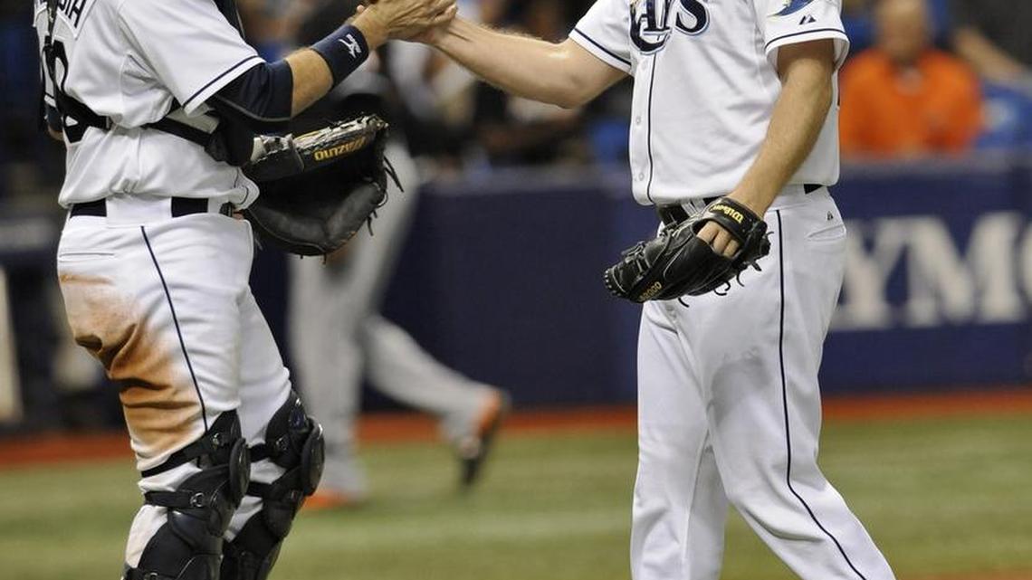 Tampa Bay Rays catcher J.P. Arencibia, left, and closer Brad Boxberger celebrate a 4-1 win over the Miami Marlins during a baseball game Thursday, Oct. 1, 2015, in St. Petersburg, Fla.