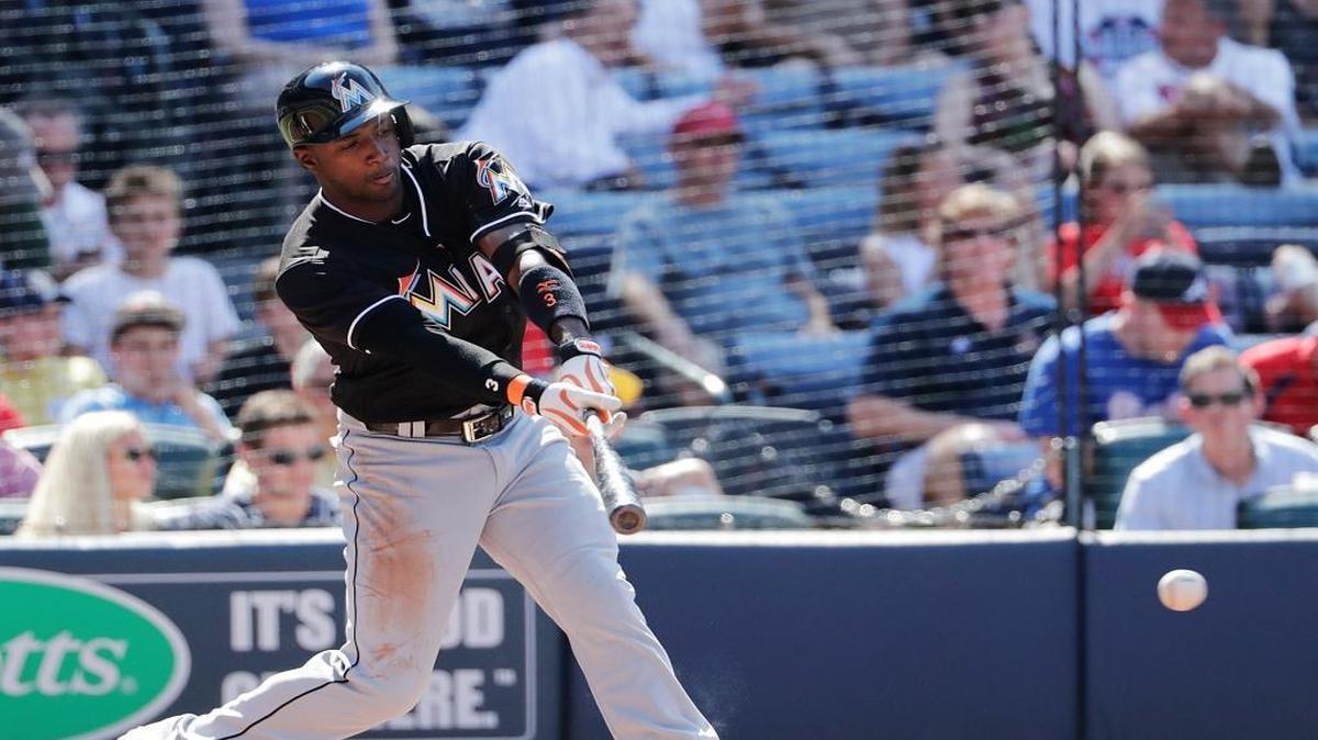 Miami Marlins' Adeiny Hechavarria singles to score teammate Cole Gillespie in the second inning of a baseball game against the Atlanta Braves, Saturday, May 28, 2016, in Atlanta.