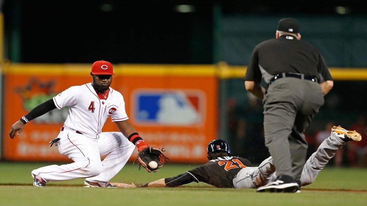 Miami Marlins' Christian Yelich slides into second base with a steal as Cincinnati Reds second baseman Brandon Phillips (4) takes the throw during the fifth inning of a baseball game, Wed., Aug. 17, 2016, in Cincinnati.