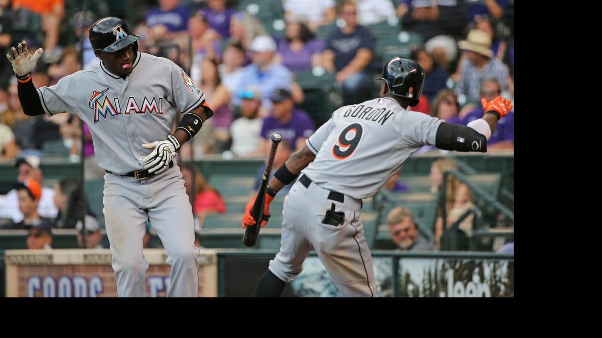 
Adeiny Hechavarria (3) of the Miami Marlins celebrates his game winning solo home run off of Boone Logan (48) of the Colorado Rockies with Dee Gordon (9) of the Miami Marlins in the 10th inning at Coors Field on June 7, 2015 in Denver. The Marlins defeated the Rockies 3-2 in 10 innings.
