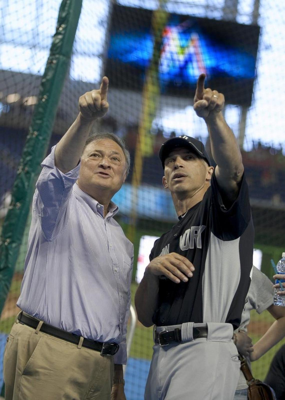 Owner Jeffrey Loria points out features of new stadium to his former manager Joe Girardi before the Exhibition game with the Miami Marlins and New York Yankees at Marlins Park in Miami on April 1, 2012.