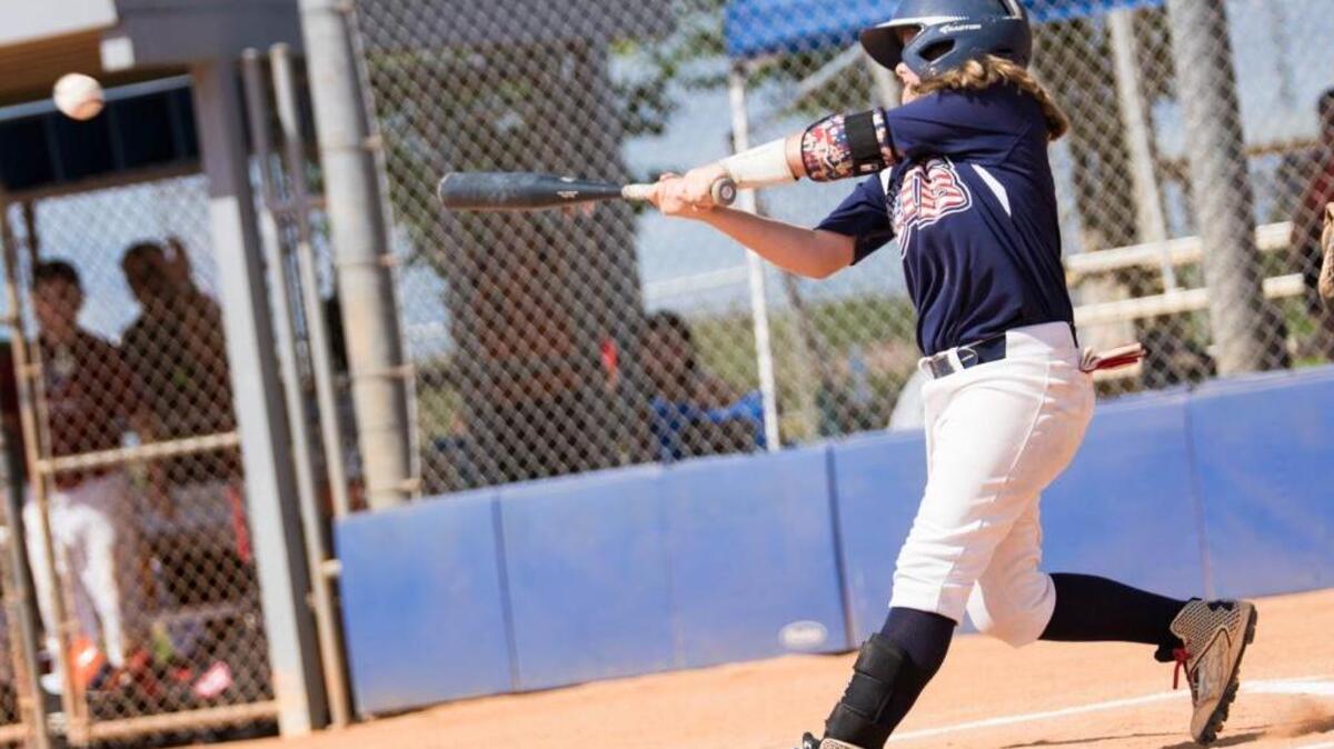 Aubrey Evans, 13, of Apopka, Florida, hits a baseball during a game this summer in Kissimmee.
