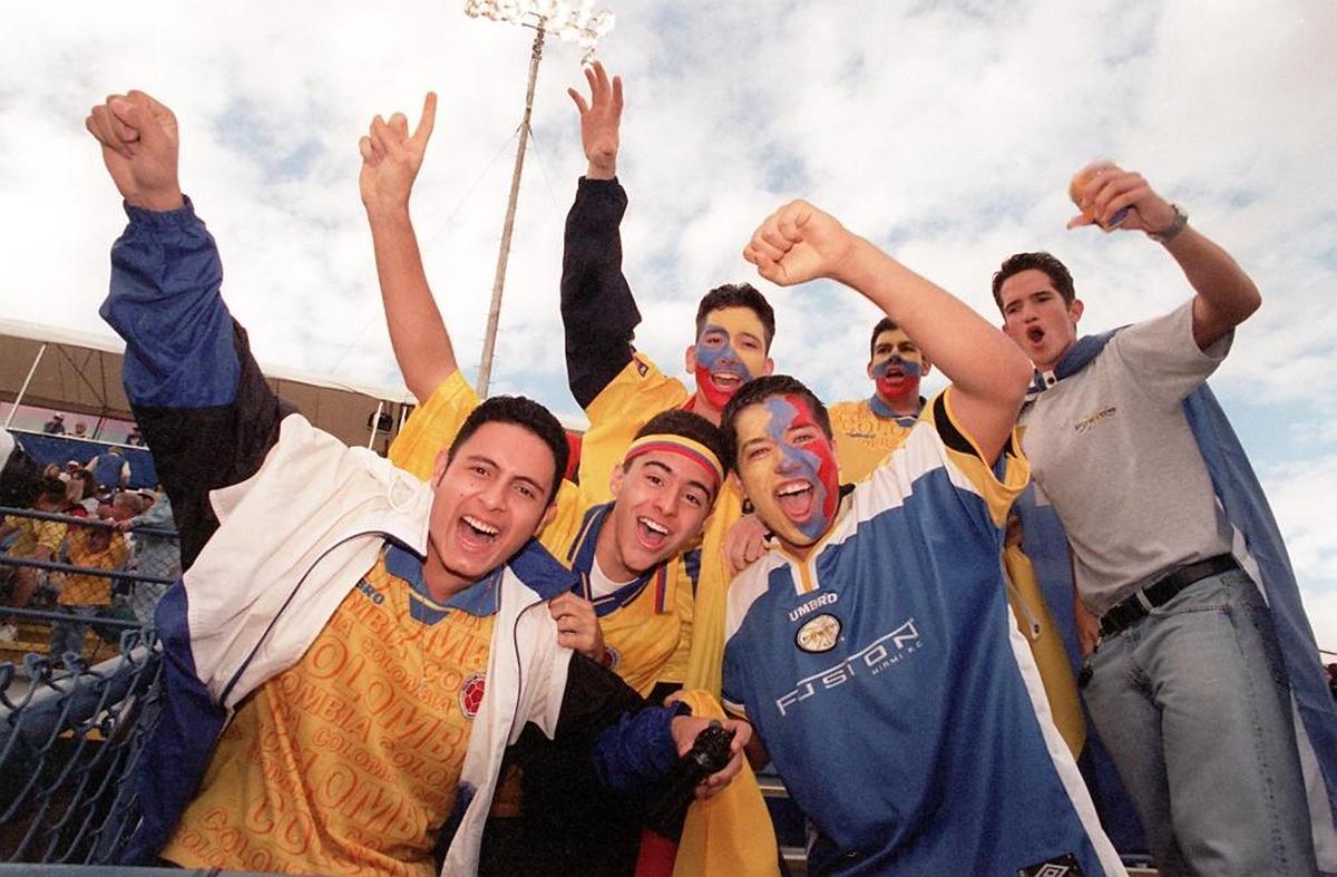 Soccer fanatics, all from Colombia, with painted faces, cheer for the Miami Fusion soccer team in Lockhart Stadium, for the opening games.