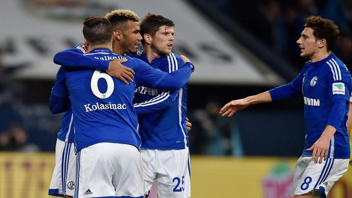 Schalke's scorer Eric Maxim Choupo-Moting, second left, is congratulated by teammates Sead Kolasinac, left, Klaas Jan Huntelaar, second right, and Leon Goretzka during the German Bundesliga soccer match between FC Schalke 04 and TSG Hoffenheim in Gelsenkirchen, Germany, Friday, Dec. 18, 2015.