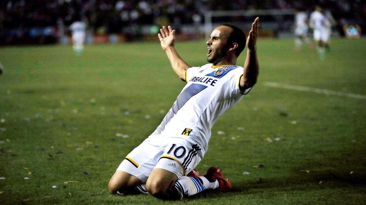 In this Nov. 9, 2014, file photo, Los Angeles Galaxy's Landon Donovan celebrates scoring a goal against Real Salt Lake during the second half of an MLS soccer Western Conference playoff series game, in Carson, Calif. Although Donovan ends his soccer career in the MLS Cup on Sunday, the LA Galaxy have resisted the notion they're trying to win a title as a parting gift for the greatest player in U.S. history. They've got plenty of motivation against the New England Revolution even without honoring Donovan.