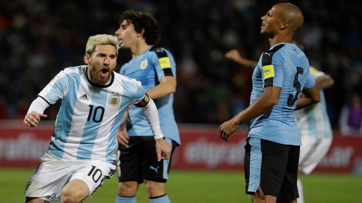 Argentina’s Lionel Messi, left, celebrates after scoring against Uruguay during a 2018 World Cup qualifying match on Thursday night. Messi came back to the national team after saying he was retired from playing for Argentina.