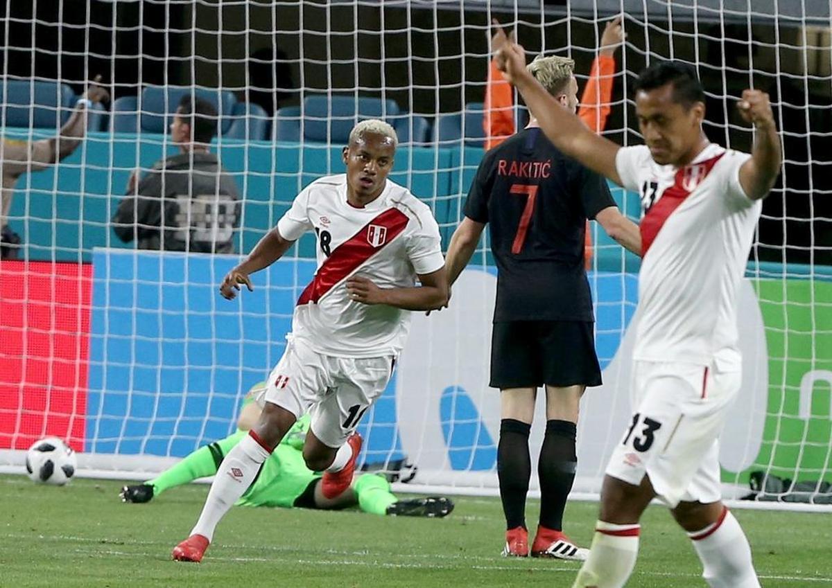 Croatia midfielder Ivan Rakitic (No. 7) and Peru midfielder Renato Tapia (No. 13) react as forward Andre Carrillo (No. 18) scores the first goal against Croatia, in the first half as Peru takes on Croatia in an exhibition match at Hard Rock Stadium on Friday, March 23, 2018.