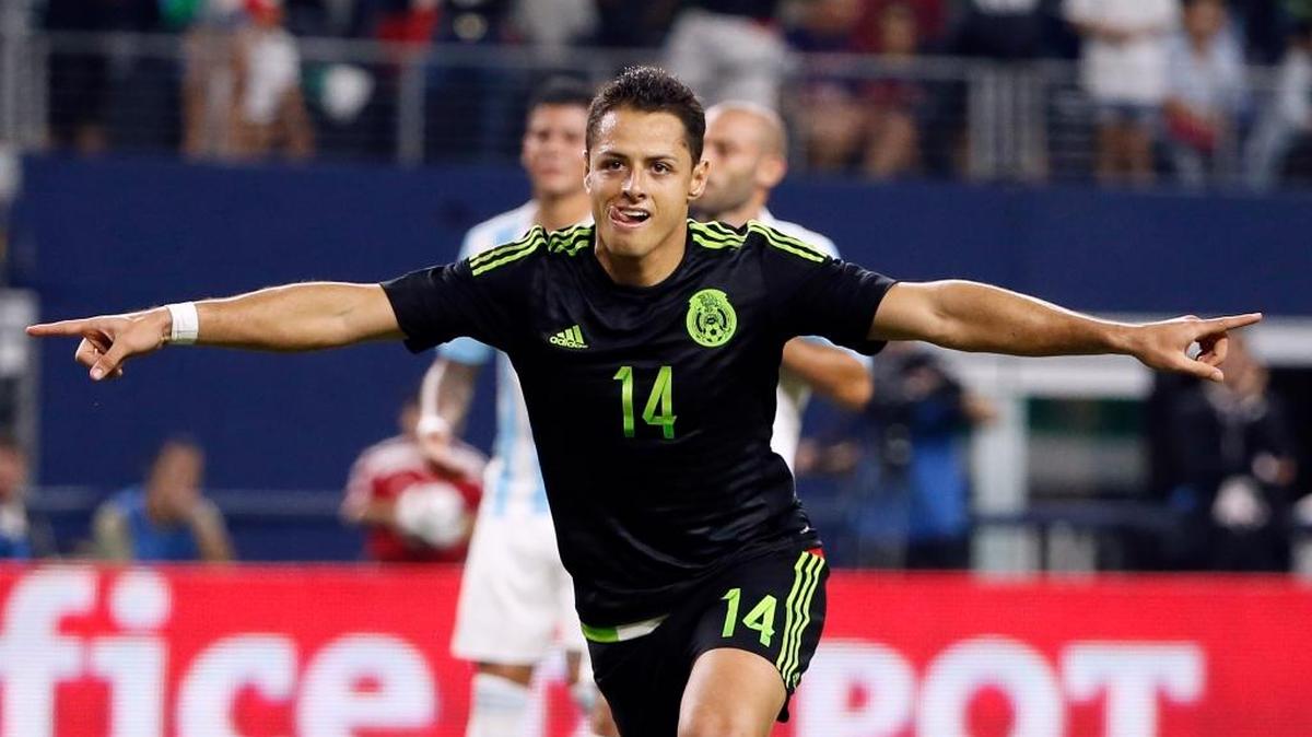 Mexico’s Javier “Chicharito” Hernandez, shown celebrating a goal during a friendly against Argentina in Arlington, Texas, on Sept. 8, 2015, injured his back Tuesday while playing for German team Bayer Leverkusen.