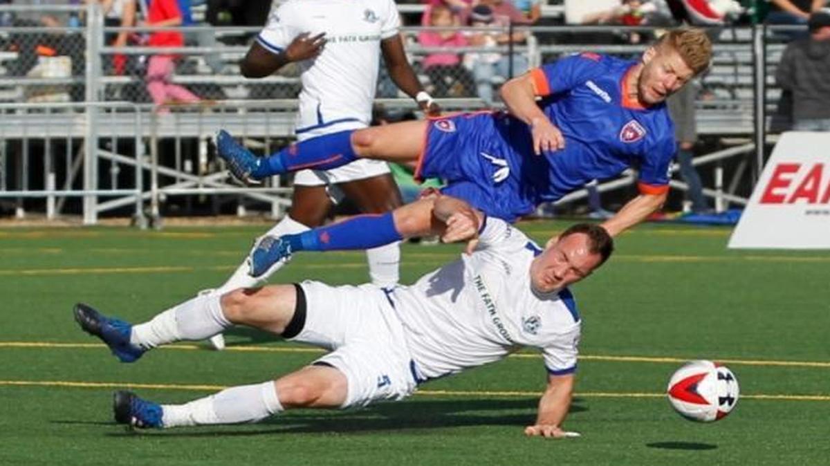 Miami FC’s Richie Ryan collides with FC Edmonton’s Albert Watson during their game Saturday, June 10, 2017, in Edmonton.