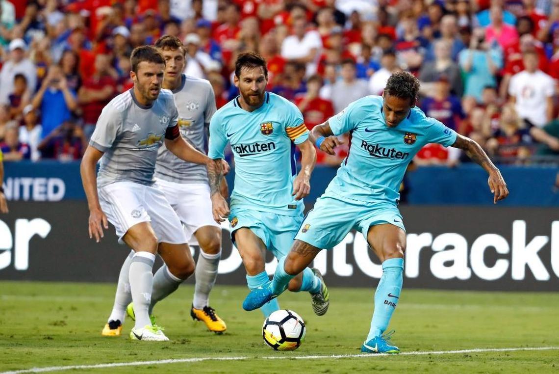 Barcelona's Neymar, right, scores a goal in front of teammate Lionel Messi, center, Manchester United's Michael Carrick, left, and Victor Lindelof during the first half of an International Champions Cup soccer match, Wed., July 26, 2017, in Landover, Md.