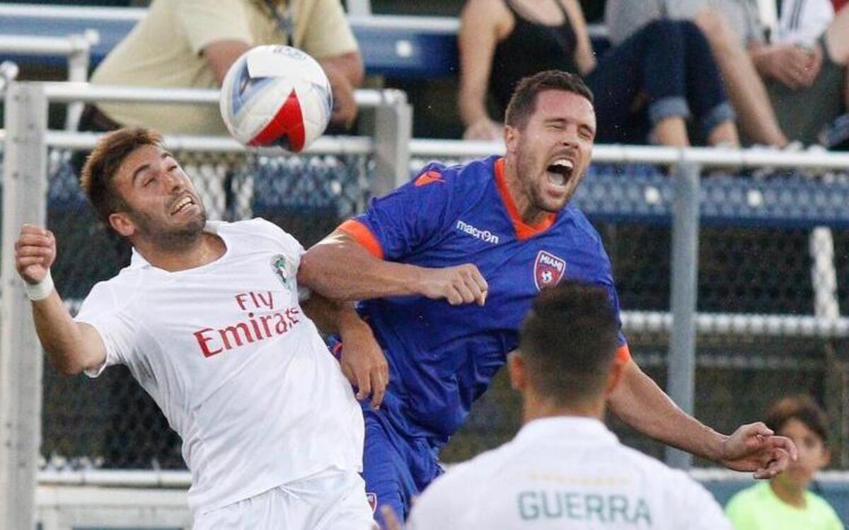 Miami FC Hunter Freeman (15) challenges New York Cosmos 's player for the ball during their soccer match on Saturday, June 24, 2017, at FIU's Riccardo Silva Stadium in Miami.