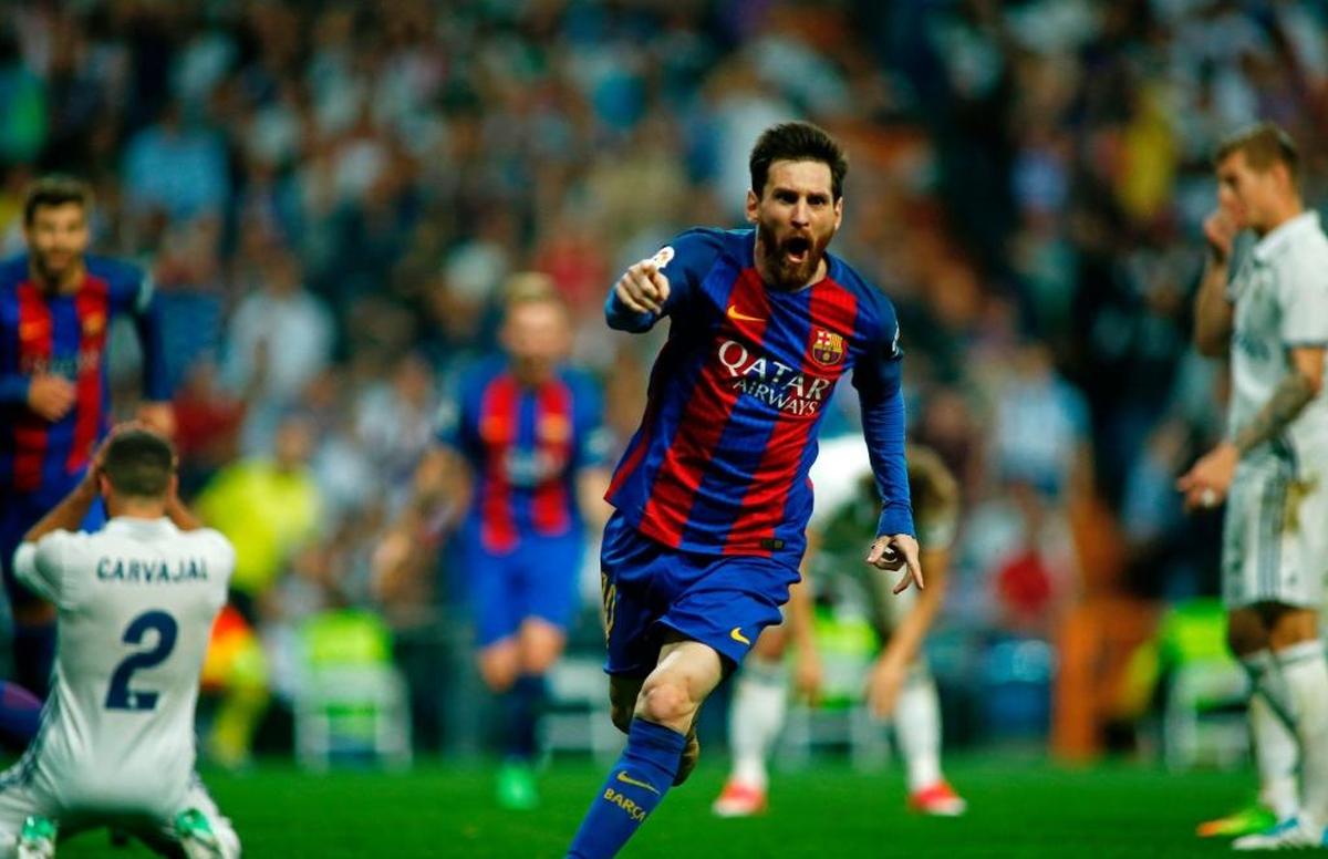 Barcelona's Argentinian forward Lionel Messi celebrates after scoring during the Spanish league Clasico football match Real Madrid CF vs FC Barcelona at the Santiago Bernabeu stadium in Madrid on April 23, 2017.