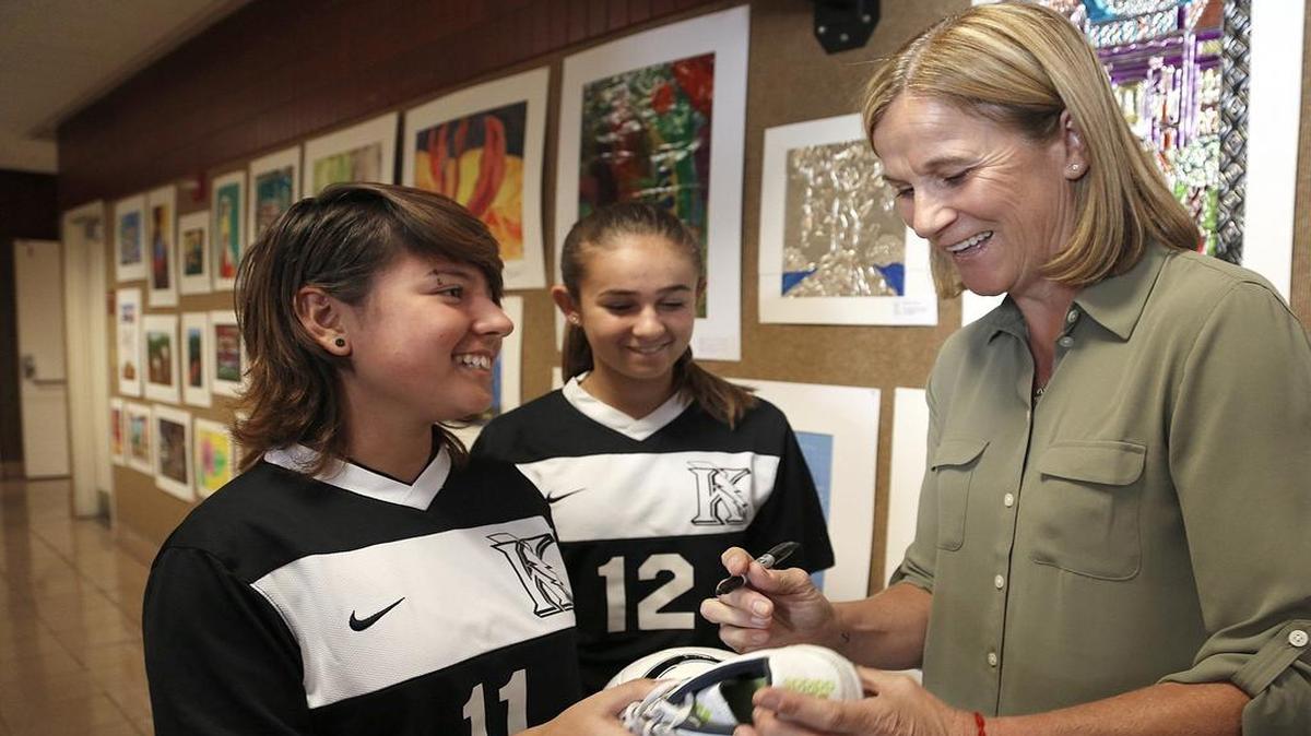 
Happy to oblige: Krop High soccer players, Maja Herrera, 15, left, and Sloane Auerbach, 15, get autographs from Jill Ellis.
