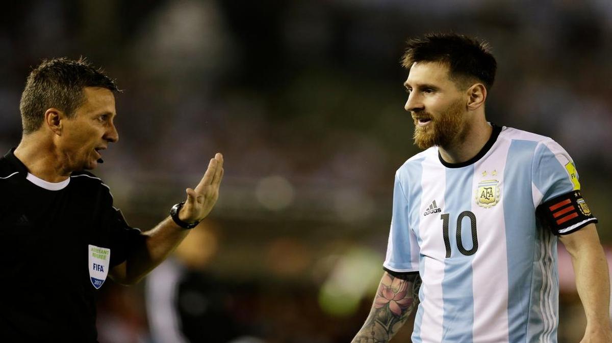 In this photo taken on March 23, 2017, Argentina's Lionel Messi argues with assistant referee Emerson Augusto de Carvalho during a World Cup qualifying match against Chile in Buenos Aires, Argentina. Messi was banned from Argentina's next four World Cup qualifiers following the match for "having directed insulting words at an assistant referee."