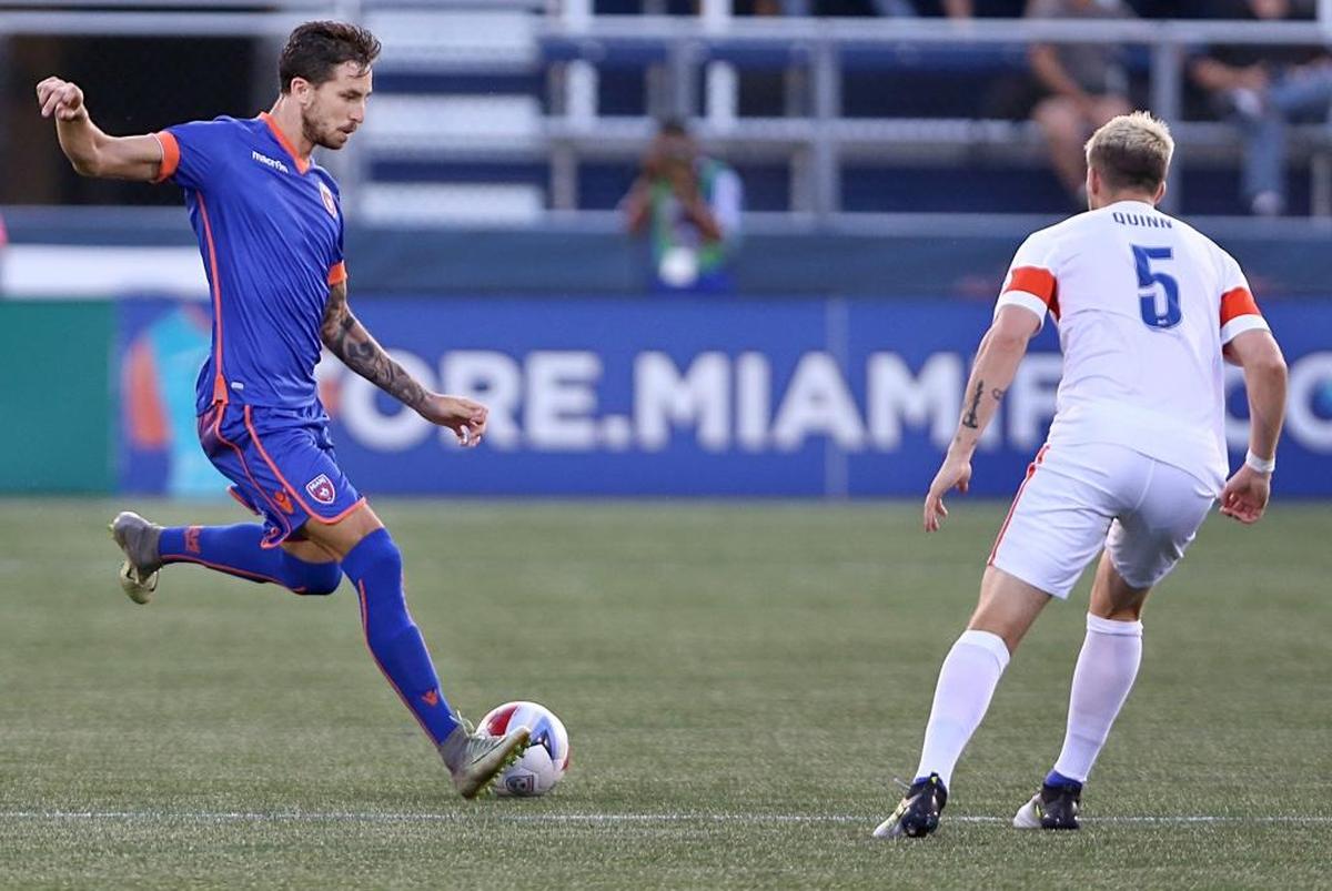 The Miami FC's forward Vincenzo Rennella, drives against FC Cincinnati's midfielder Aodhan Quinn, during the first half of quarterfinals of the U.S. Open Cup at Riccardo Silva Stadium at FIU in Miami on Wed., Aug. 2, 2017.