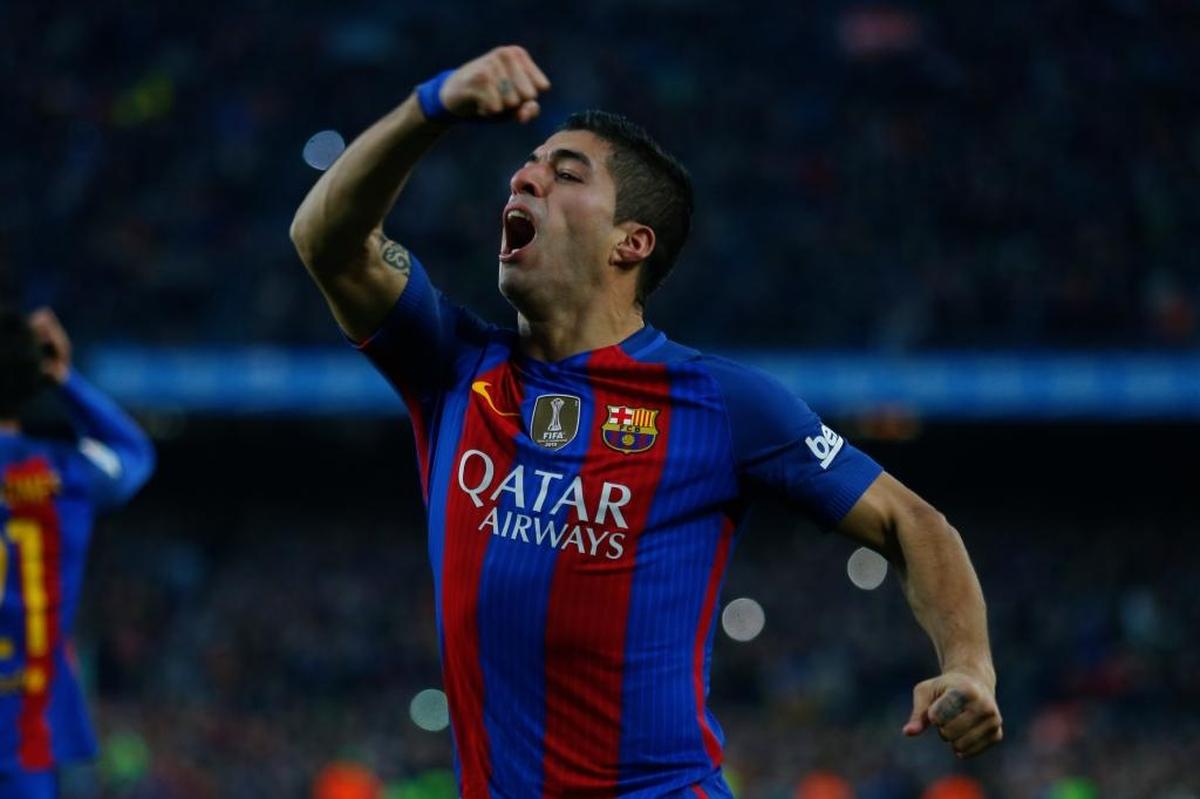 Barcelona's Luis Suarez celebrates after scoring the opening goal during the Spanish La Liga soccer match between FC Barcelona and Real Madrid at the Camp Nou in Barcelona, Spain, Sat., Dec. 3, 2016.