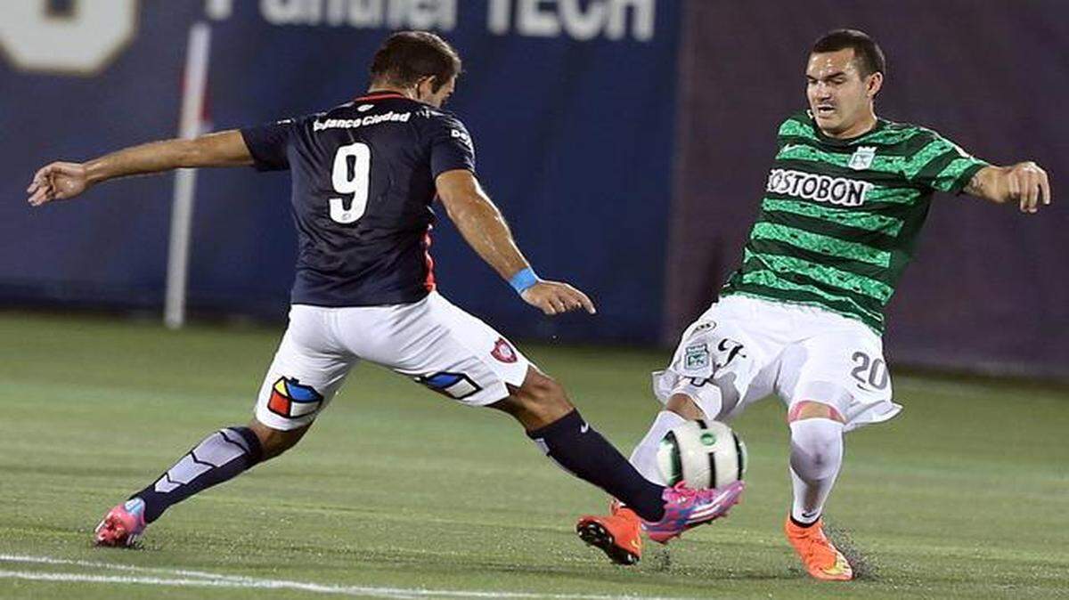 
San Lorenzo's Martin Cauteruccio (9) blocks Atletico's Alejandro Bernal (20) during the first half of their Copa de Campeones match at FIU Stadium in Miami on Saturday, Jan. 17, 2015.
