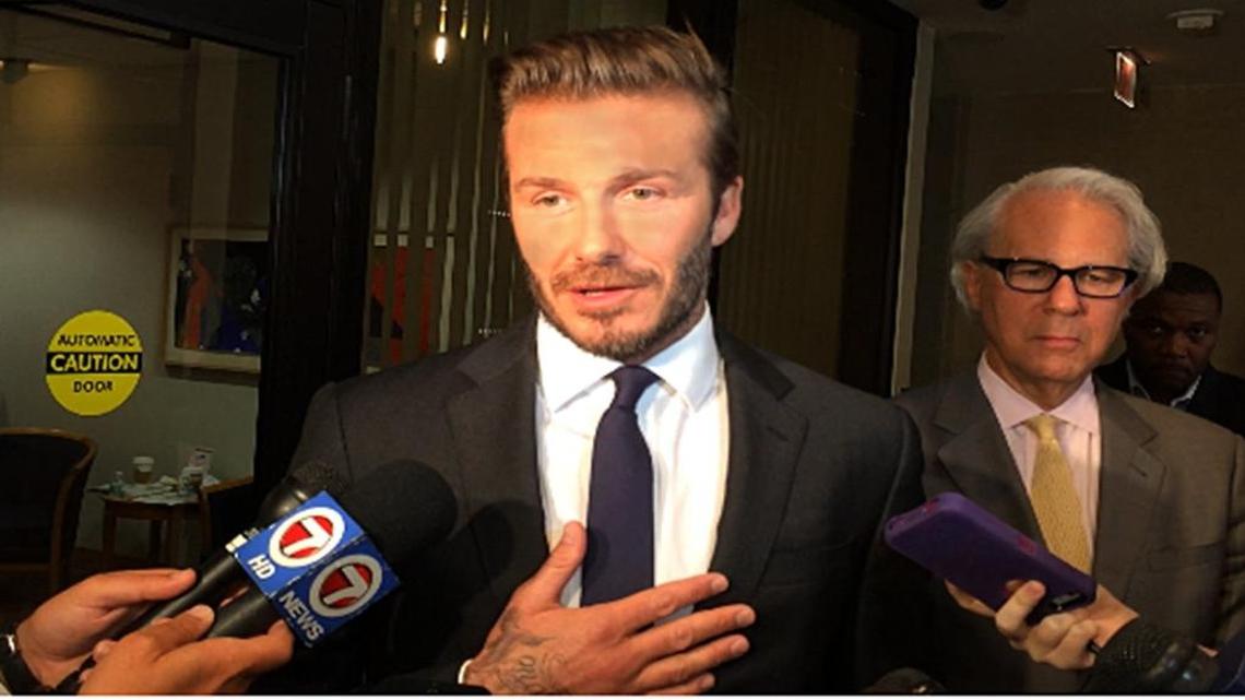 David Beckham speaks with reporters after meeting with officials at Miami-Dade County government center.