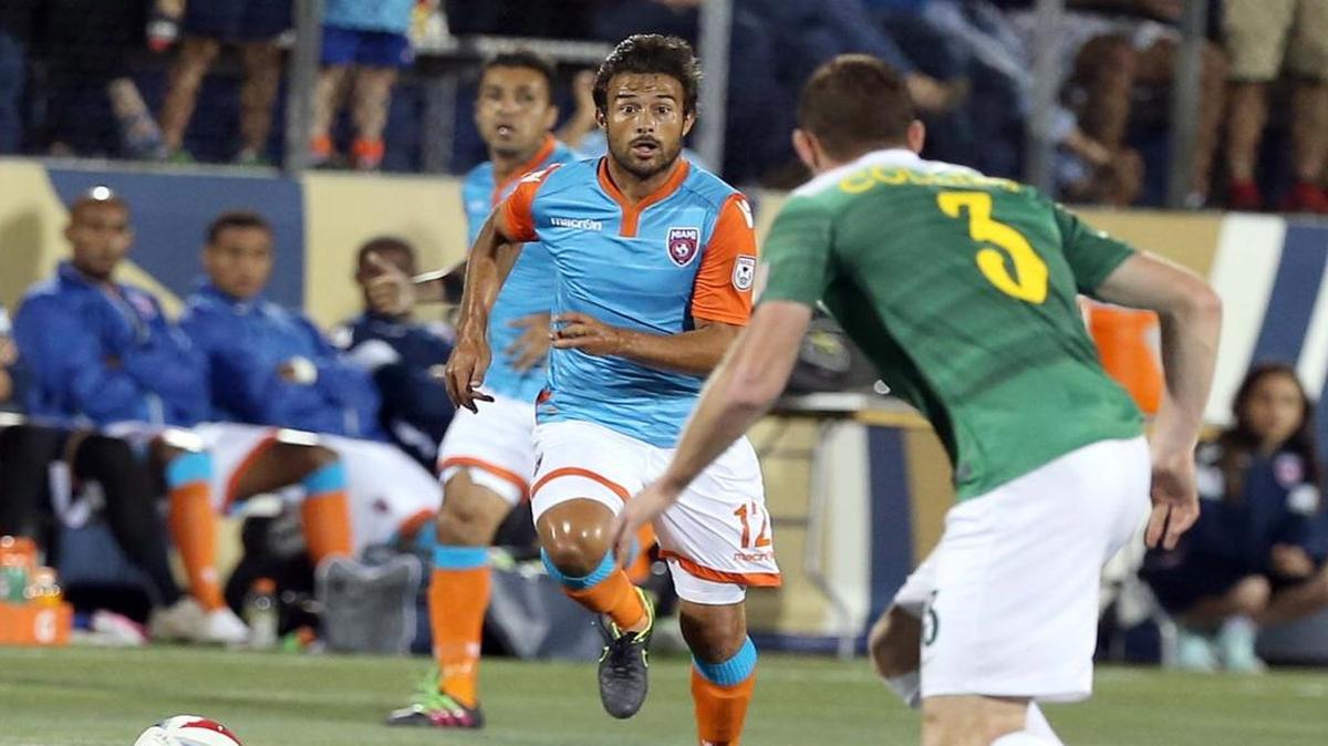 Miami FC forward Dario Cvitanich, left, drives against Tampa Bay Rowdies defender Neil Collins (3) during their game at FIU Stadium in Miami on April 9, 2016.