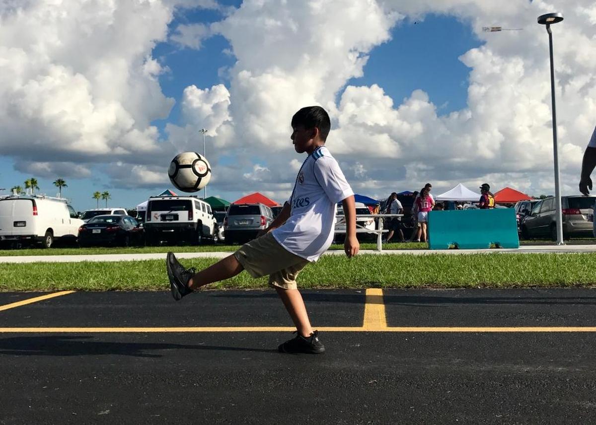 Jonathan Amaya, 10, kicks a soccer ball in Hard Rock Stadium’s parking lot a few hours before El Clásico. The New Yorker, a left-winger on his soccer team back home, was a little disappointed he wasn’t going to see Christiano Ronaldo play. But he was still excited to see Real Madrid play, especially Sergio Ramos.