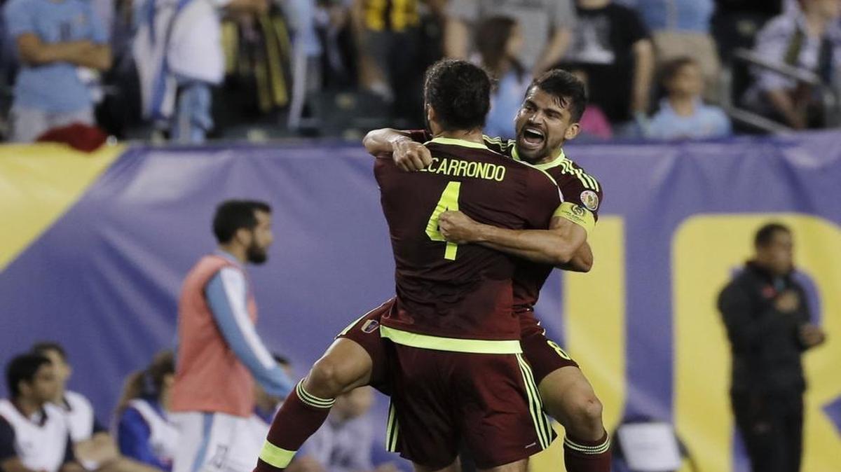 Oswaldo Vizcarrondo (4) and Tomas Rincon start the celebration after Venezuela shocked Uruguay, winning the Copa America Group C match 1-0 on Thursday in Philadelphia.