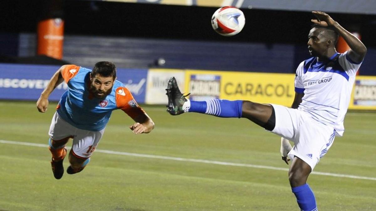 Miami FC defender Rhett Bernstein (18) goes for a diving header during their game against FC Edmonton at at FIU Stadium on May 28.
