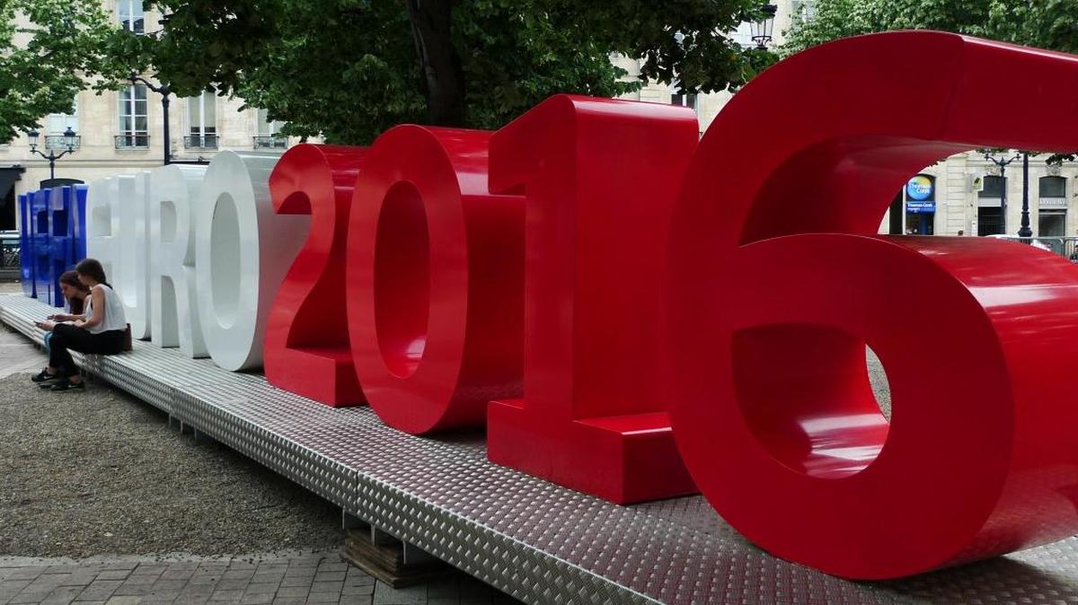 Two girls sit in front of a Uefa Euro 2016 installation, in Bordeaux, France, Thurs., June 9, 2016. The Euro 2016 Soccer Championship starts with the opening match on Fri., June10, 2016 in Paris.