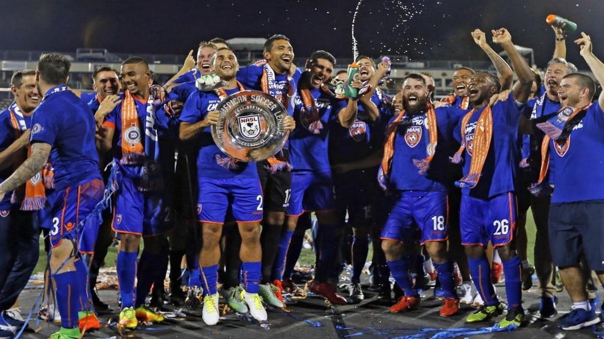 Miami FC celebrates with the championship trophy after defeating San Francisco Delta in Riccardo Silva Stadium at FIU on Sat., July 8, 2017.