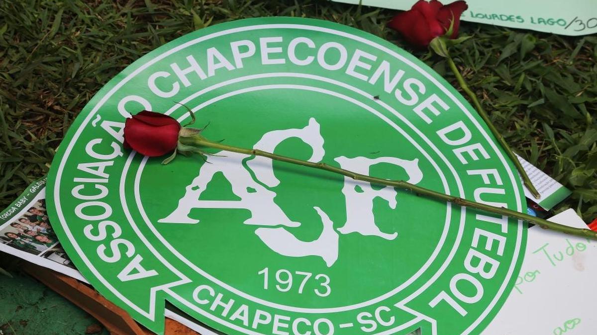A red rose sits on top of the Chapecoense soccer team logo outside their home stadium in Chapeco, Brazil.