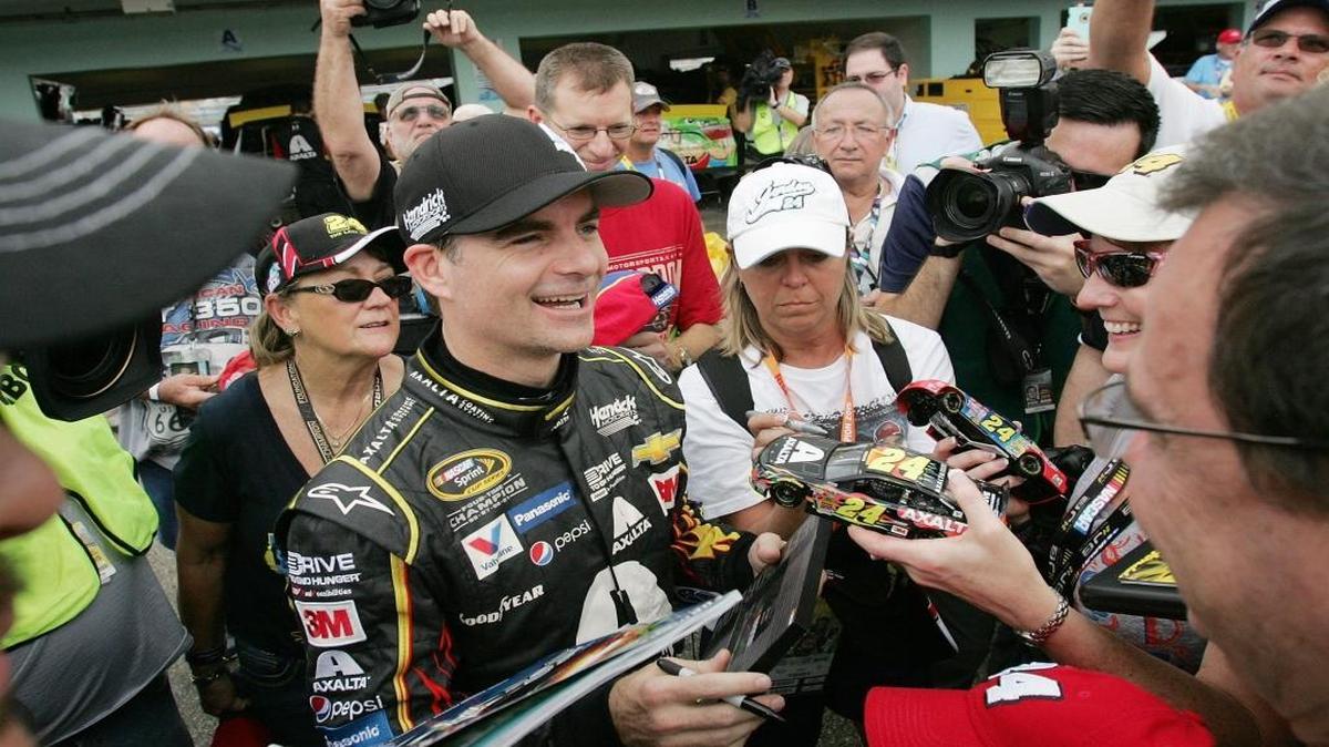 NASCAR driver Jeff Gordon (car #24) signs memorabilia for the fans during the Ford EcoBoost 400 Sprint Cup Series practice on Saturday, November 21, 2015 at Homestead-Miami Speedway.