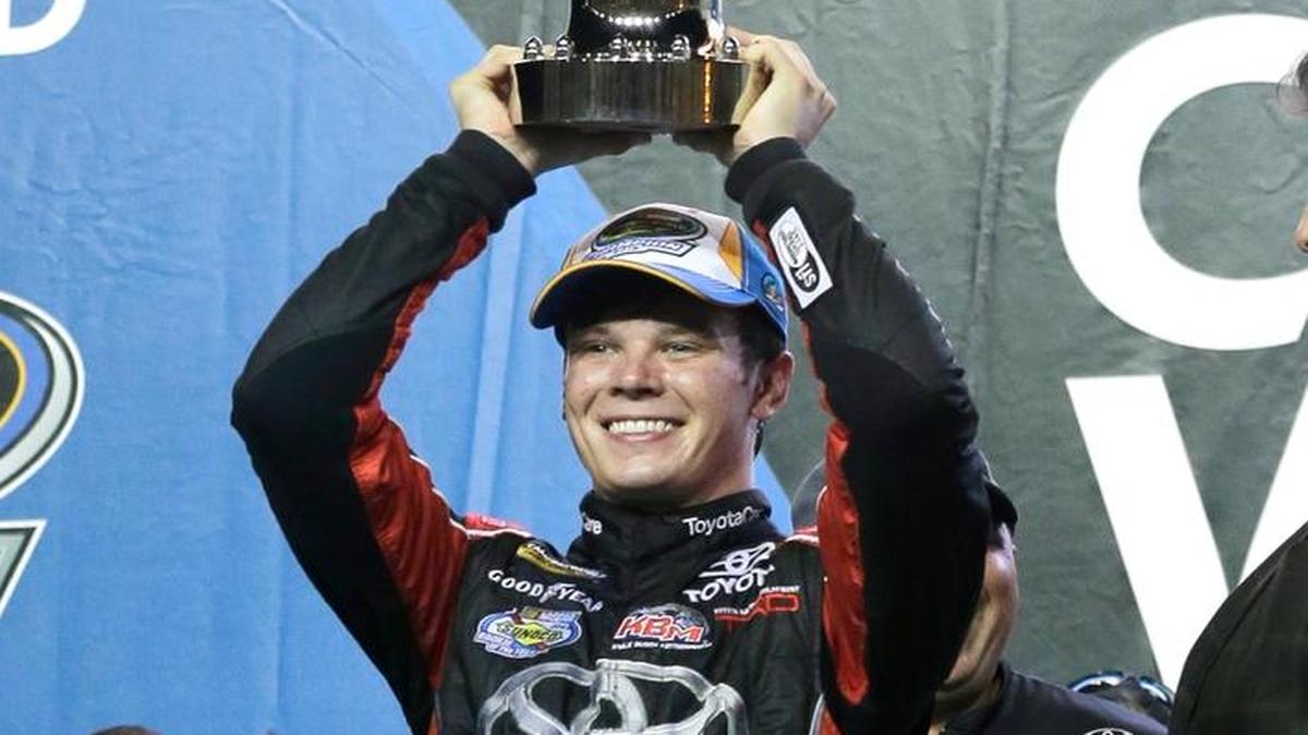 Erik Jones raises the trophy after winning the season title following the NASCAR Trucks auto race Friday, Nov. 20, 2015 at Homestead-Miami Speedway in Homestead, Fla.