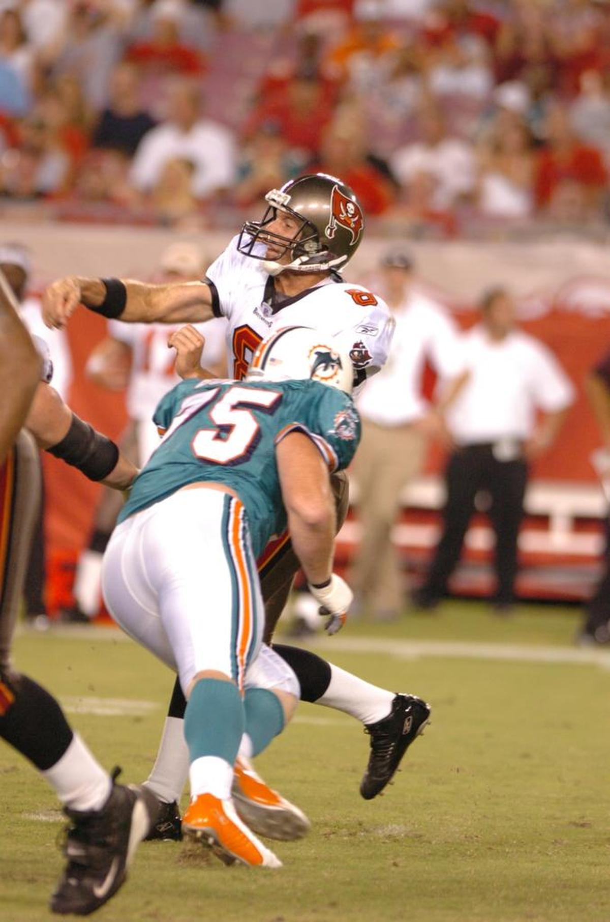 Nate Bolling pressures Tampa Bay Buccaneers quarterback Brian Griese during his time as a defensive lineman with the Miami Dolphins.