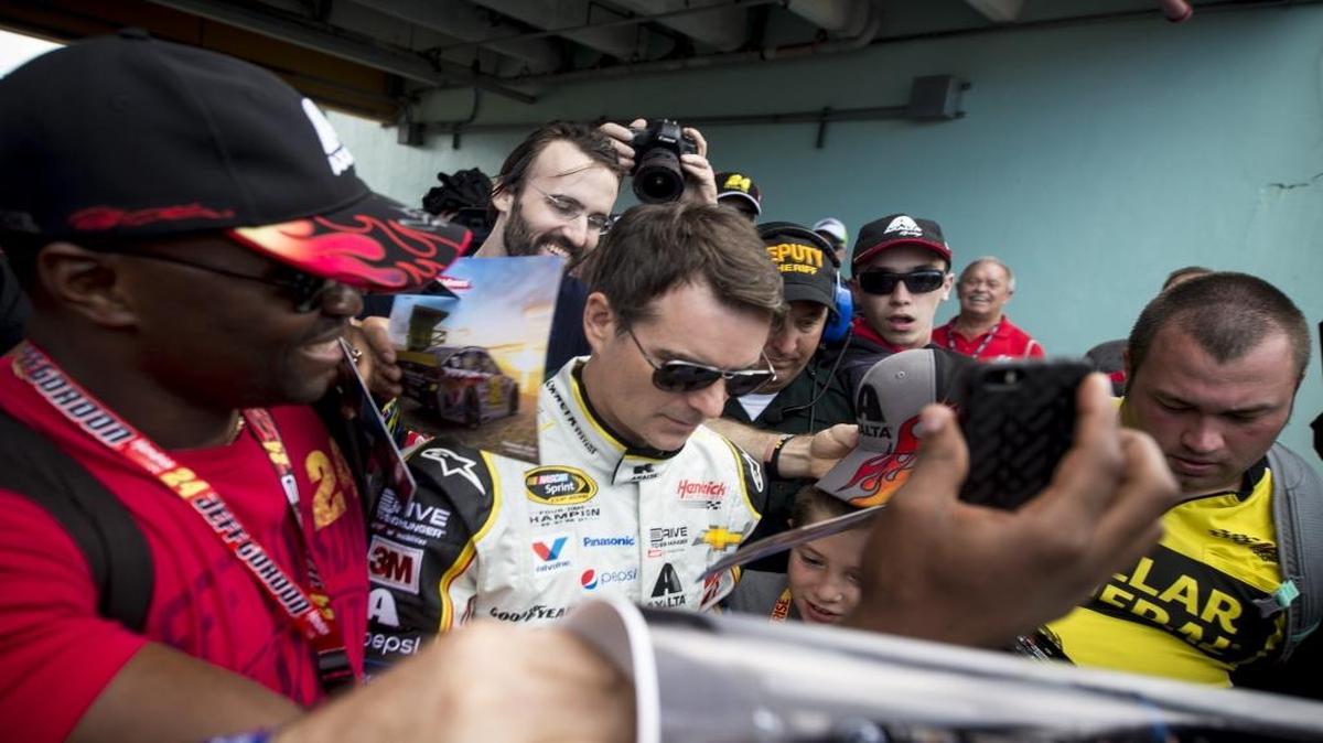 Jeff Gordon signs autographs for his fans Sunday at Homestead-Miami Speedway before his final race.