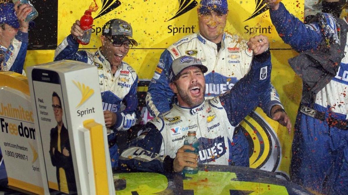 Jimmie Johnson gets a post-race shower after winning the NASCAR Sprint Cup championship and Ford EcoBoost 400 at Homestead-Miami Speedway on Sunday.