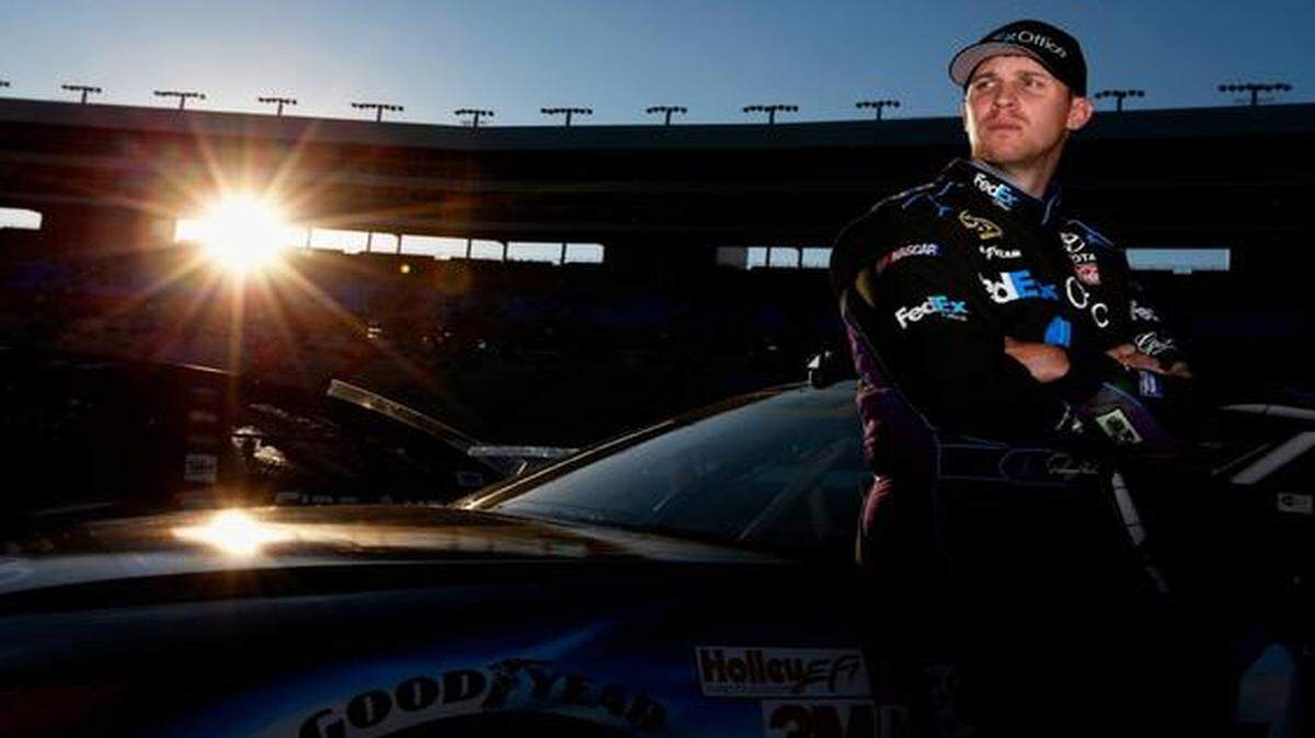 
Denny Hamlin, driver of the #11 FedEx Office Toyota, stands by his car during Pinnacle Propane Qualifying for the NASCAR Sprint Cup Series AAA Texas 500 at Texas Motor Speedway on October 31, 2014 in Fort Worth, Texas. 
