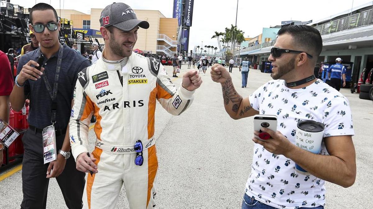 NASCAR driver Daniel Suarez (19 ) fist pumps fan Gustavo Barajas during Ford Championship Weekend at Homestead Miami Speedway on Saturday, November 17, 2018.