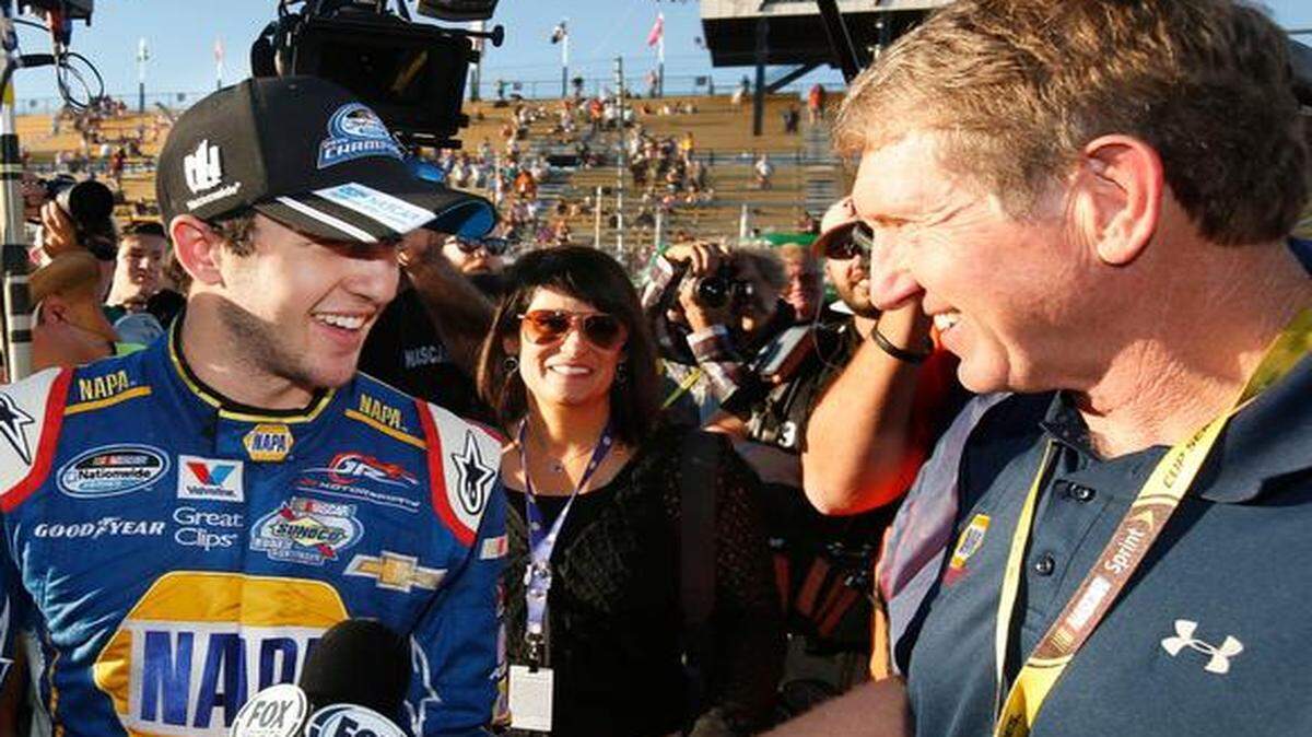 
Chase Elliott, 18, smiles as he celebrates his NASCAR Nationwide Championship with his father Bill Elliott, right, after finishing fifth at the NASCAR Nationwide Series auto race at Phoenix International Raceway, Saturday, Nov. 8, 2014, in Avondale, Ariz. 
