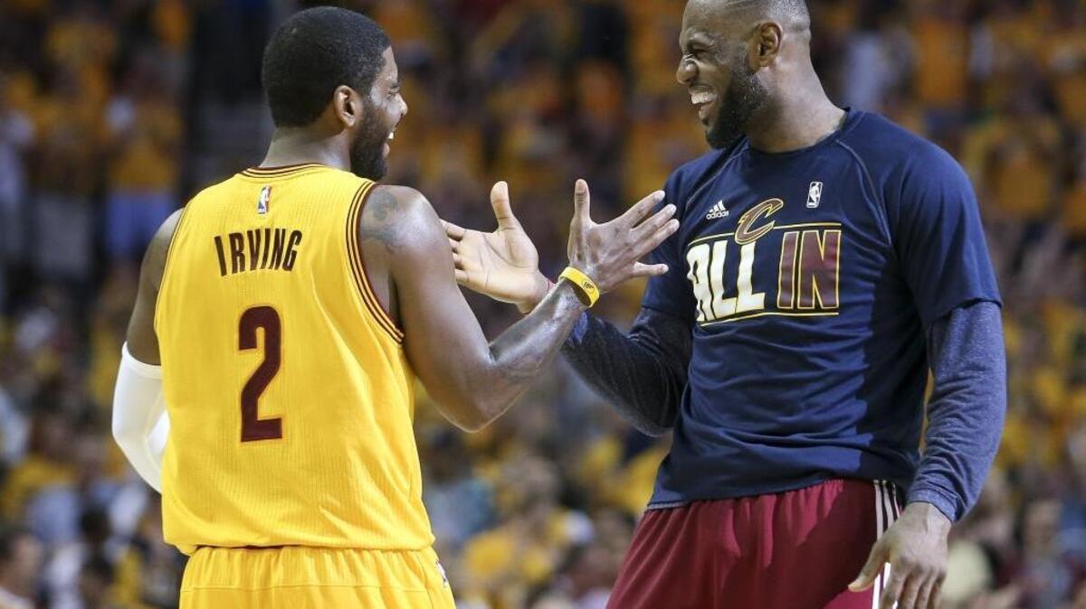 LeBron James and Kyrie Irving enjoy a big play during Game 4 of the Eastern Conference Finals against the Atlanta Hawks on May 26, 2015.