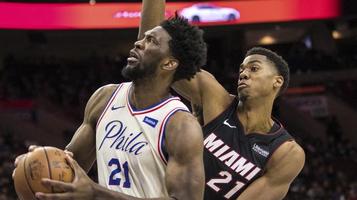 Philadelphia 76ers' Joel Embiid, left, of Cameroon, drives to the basket as he gets past Miami Heat's Hassan Whiteside, right, during the second half of an NBA basketball game, Friday, Feb. 2, 2018, in Philadelphia.
