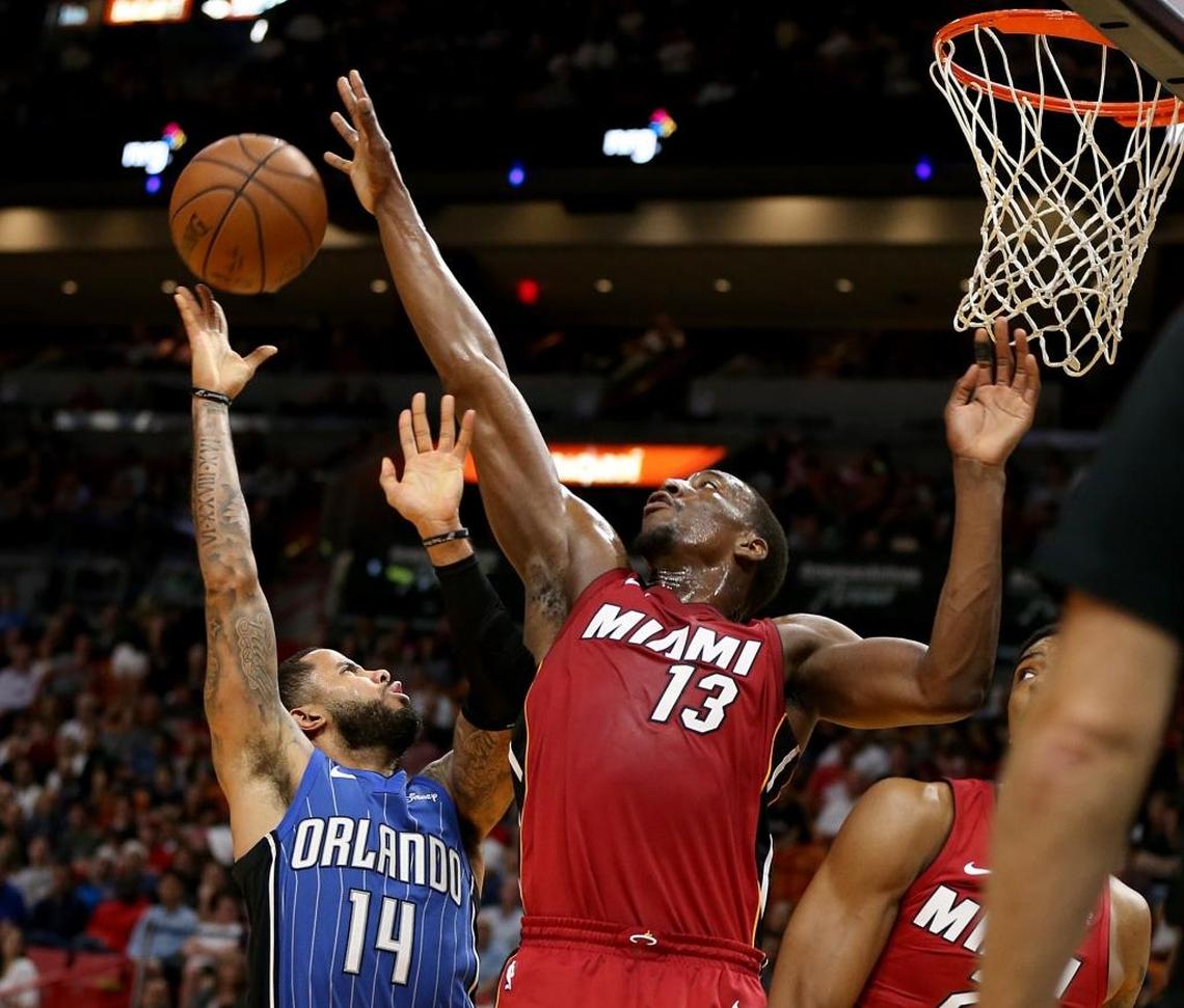 Miami Heat center Bam Adebayo blocks a shot under the basket by Orlando Magic guard D.J. Augustin in the fourth quarter of the Heat’s 107-89 victory at AmericanAirlines Arena in Miami on Tuesday, Dec. 26, 2017.