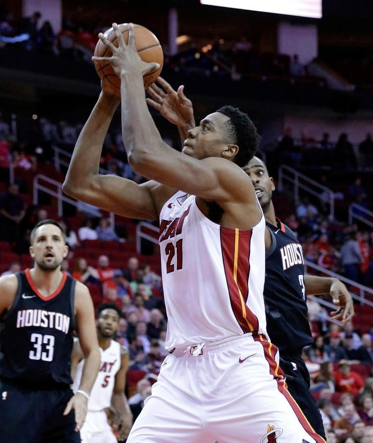 Miami Heat center Hassan Whiteside (21) shoots past Houston Rockets guard Chris Paul (3) as forward Ryan Anderson (33) looks on during the first half of an NBA basketball game Monday, Jan. 22, 2018, in Houston.