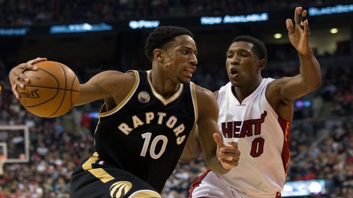 Toronto Raptors' DeMar DeRozan, left, drives for the net as Miami Heat's Josh Richardson defends during the first half of an NBA basketball game in Toronto on Saturday, March 12, 2016.