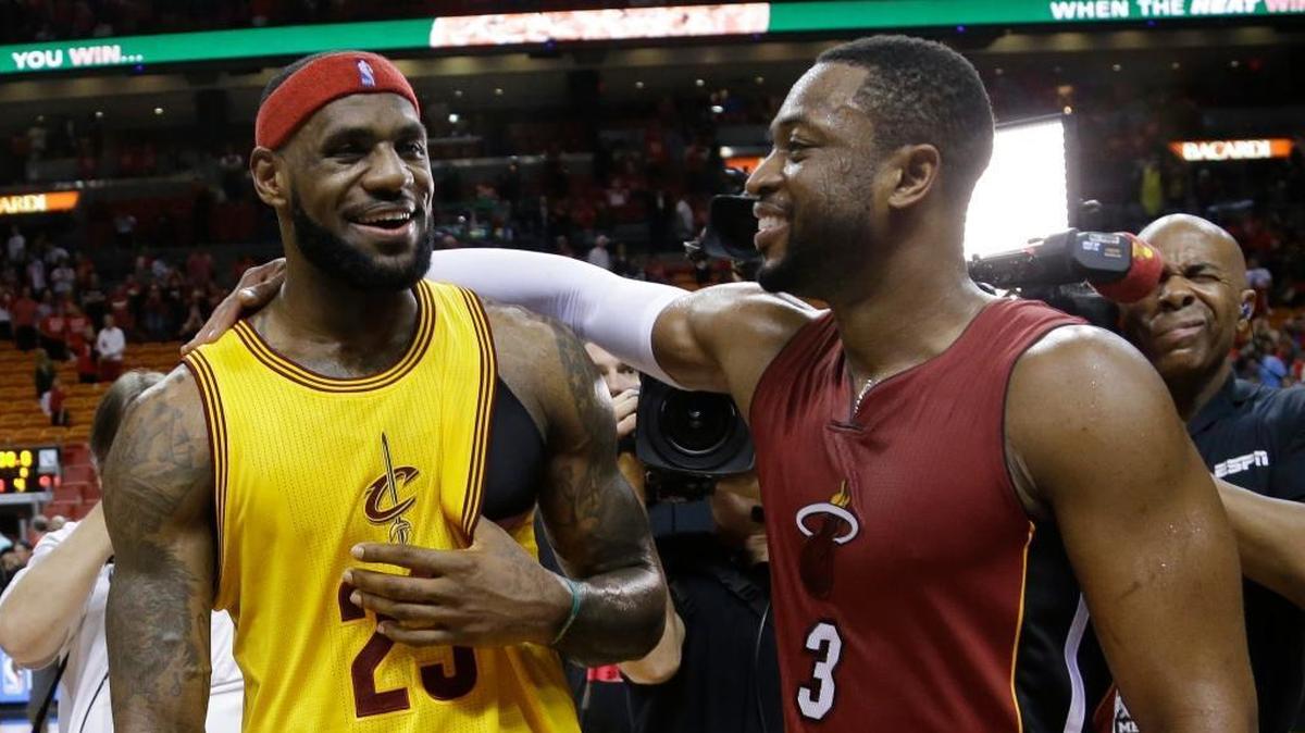 FILE - In this Dec. 25, 2014, file photo, Cleveland Cavaliers forward LeBron James (23) and Miami Heat guard Dwyane Wade talk following an NBA basketball game in Miami.